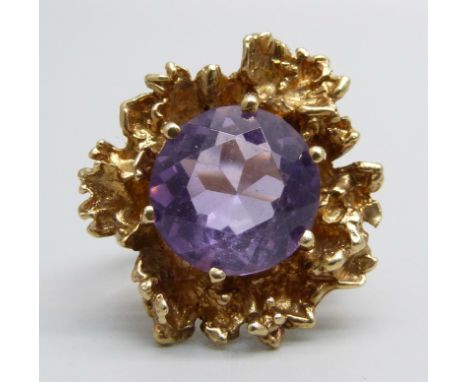 A 9ct yellow gold and amethyst design ring set with round mixed-cut light/mid colour 12mm diameter amethyst in claw setting, 
