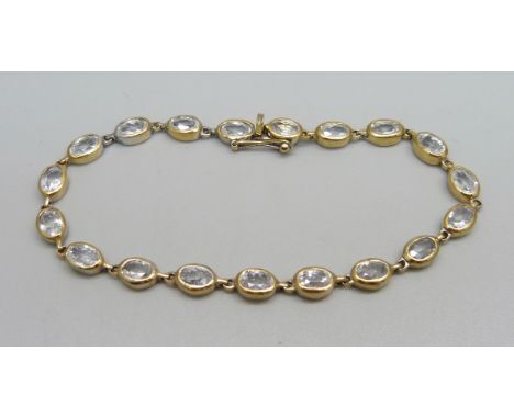 A silver gilt and crystal line bracelet, marked on end ring 