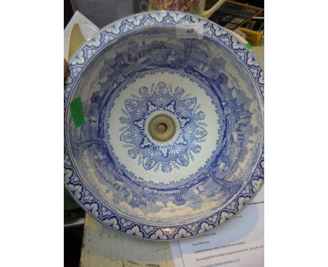 Original circular Victorian blue and white bathroom sink with original brass outlet