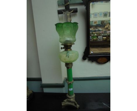 A fine and tall oil lamp, brass based with glass central stem oil holder and green glass shade and funnel, in fine condition.