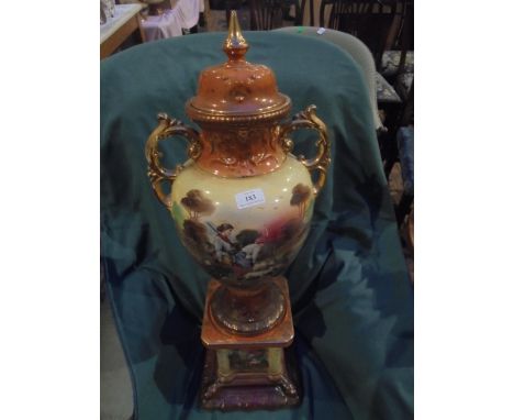 Extremely large Victorian decorative piece. Ceramic base with urn style vase and lid. Rural countryside scene.