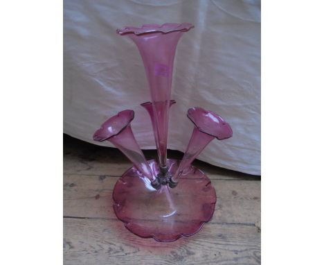 Small cranberry epergne with central flute and three matching side flutes on base.