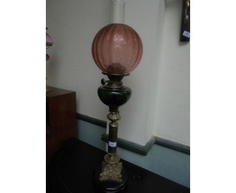 Fine single oil lamp, wood base, brass with glass oil container and pink shade.