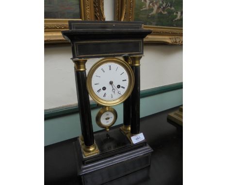 Ebonised portico clock with enamel dial and central pendulum, pillar featured.