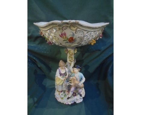 Large table centrepiece, continental, highly decorated with figure of boy and girl holding lamp marked T with cross to base