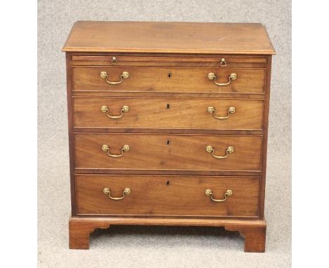 A SMALL GEORGIAN MAHOGANY CHEST, late 18th century, the moulded edged top over brushing slide and four graduated long cockbea