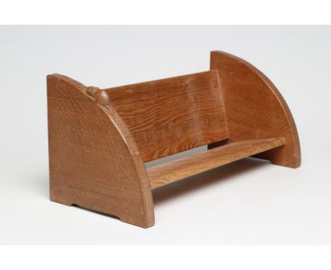 A ROBERT THOMPSON ADZED OAK BOOK TROUGH of quadrant form with carved mouse trademark in high relief, on bracket feet, 17 3/4"