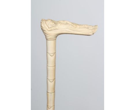 AN ANGLO INDIAN SECTIONAL IVORY WALKING STICK, 19th century, the handle carved as a reclining female wearing a sari type robe