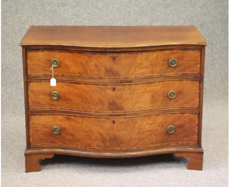 A GEORGIAN MAHOGANY CHEST, third quarter 18th century and later, of serpentine form with rosewood banding and stringing, the 