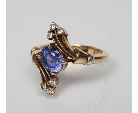 A SAPPHIRE AND DIAMOND COCKTAIL RING, the oval facet cut sapphire diagonally claw set to triple edge bars each with three sma