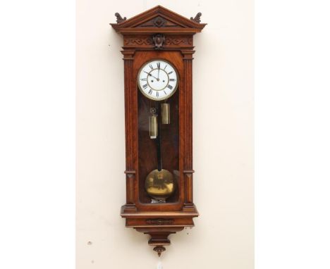 A WALNUT VIENNA TYPE WALL CLOCK, the eight day two train movement with anchor escapement striking on a gong, 7 1/4" two piece