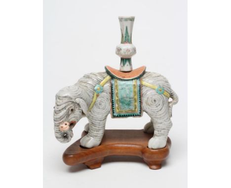 A CHINESE PORCELAIN JOSS STICK HOLDER/INCENSE BURNER modelled as an elephant with orange, green and yellow howdah and (possib