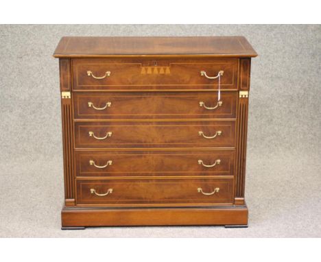A WALNUT AND EBONISED SECRETAIRE CHEST, modern, of oblong form with stringing and gilt metal mounts, moulded edged quarter ve