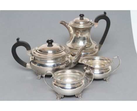 A FOUR PIECE TEA SERVICE, maker Mappin &amp; Webb, Birmingham 1926, of baluster form with straight gadrooned rims, raised upo