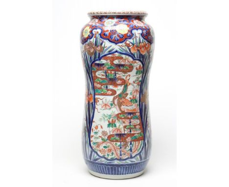 AN IMARI PORCELAIN STICK STAND of slightly waisted cylindrical form painted in typical palette with panels of stylised landsc