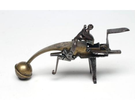 AN 18TH CENTURY FLINTLOCK TINDER LIGHTER, of brass and steel construction, top action engraved with a female bust and side-do