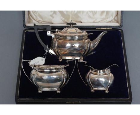A BACHELOR'S COMPOSITE EDWARDIAN THREE PIECE TEA SERVICE, maker's mark J.R., Sheffield 1904 (teapot) and 1909, of plain oblon