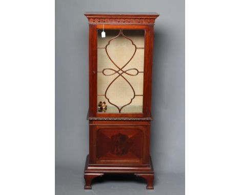 A MAHOGANY PIER DISPLAY CABINET, early 20th century, of oblong form with foliate carved waist banding, moulded lambrequin fri