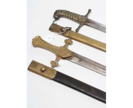 AN 1856 PATTERN DRUMMER'S HANGER, with 20 3/4" double edged blade, brass hilt with VR in relief and brass mounted leather sca