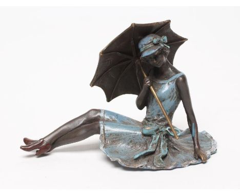 AN EROTIC BRONZE FIGURE modelled as a young lady in 1920's style blue enamelled dress and hat, seated holding a parasol, base