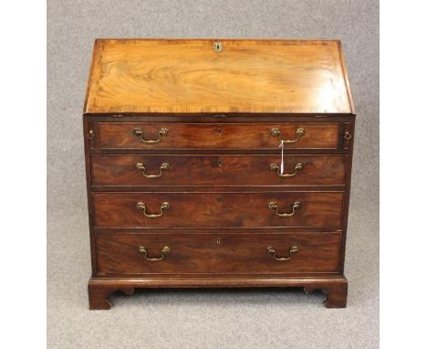 A GEORGIAN MAHOGANY BUREAU, late 18th century, the banded fall front with herringbone stringing opening to fitted interior, t
