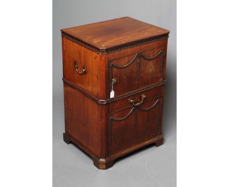 A GEORGIAN MAHOGANY BEDSIDE CABINET, late 18th century, of canted oblong form, the hinged banded top with arcaded frieze open