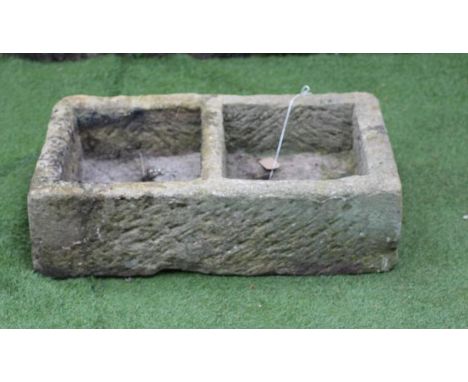 A SANDSTONE TROUGH of well cut oblong form with central division, 32" x 18" x 9", together with a sandstone sink of shallow o