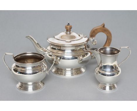 A THREE PIECE TEA SERVICE, maker Garrard &amp; Co. Ltd., Sheffield 1979, of baluster form, comprising squat teapot and hinged