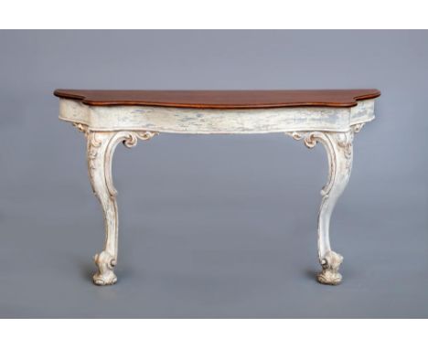 A CARVED AND PAINTED MAHOGANY(?) CONSOLE TABLE, 19th century, of serpentine form, moulded edged mahogany top, plain frieze, r