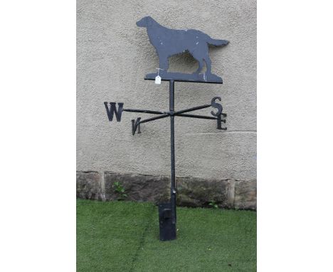 A METAL WEATHER VANE, 20th century, the turned stem issuing the compass points on square branches, sheet metal flat coat retr