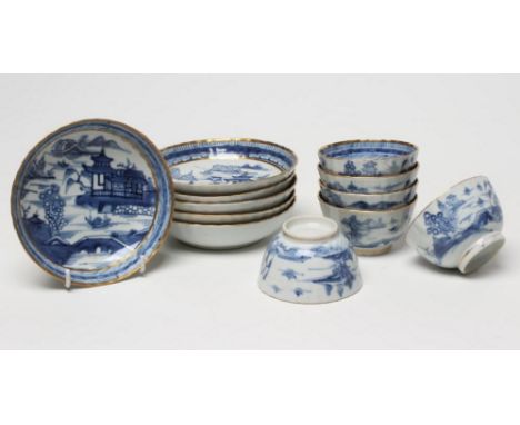 A SET OF SIX CHINESE PORCELAIN RIBBED TEABOWLS AND SAUCERS painted in underglaze blue with a landscape with bridge within sol