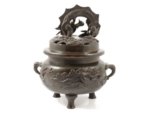 Chinese bronze tripod incense burner, cast decoration, arched dragon handle to the domed lid, 25cm.