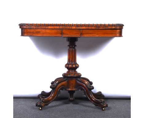 William IV rosewood card table, replaced baize, fluted swollen column and craved four-arm base, lion paw feet, on casters, wi