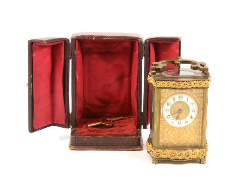 French brass cased carriage clock, serpentine case with cast outlines, timepiece movement, 13cm, with key and travelling case