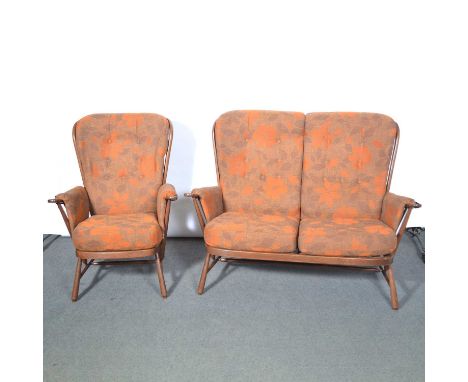 Ercol, a two-piece 'Evergreen' lounge suite, comprising two-seat highbacked sofa, and single armchair, with orange and brown 