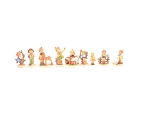 Nine Goebel Hummel figurines, various groups.
