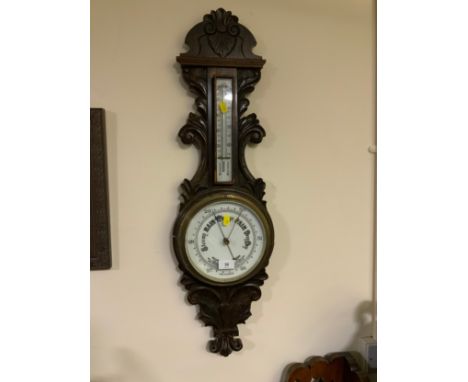 An oak carved aneroid barometer