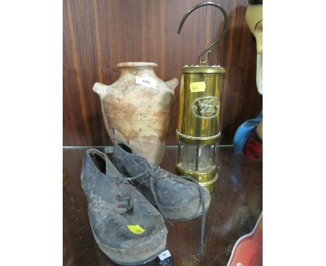 A miners lamp together with a Roman style pot and a pair of antique childs clogs