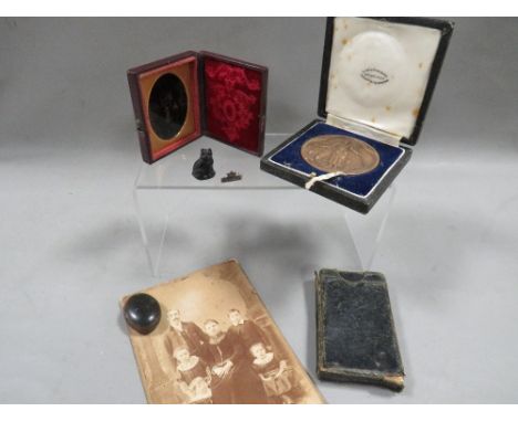 A bag of collectables including cased bronze medal, Victorian photographs etc