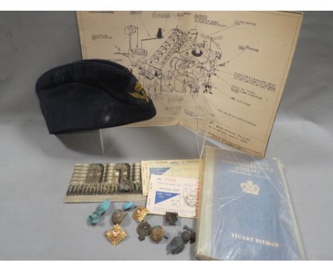 A box of military collectables, including badges, cap etc