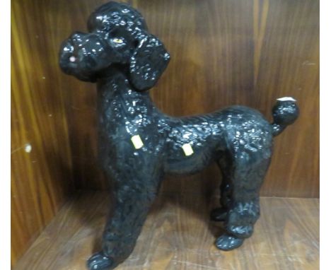 A large ceramic figure of a poodle