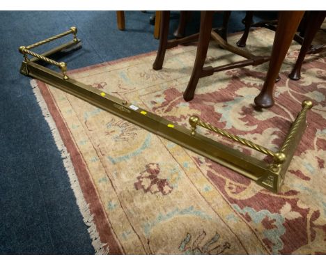 A heavy brass extending fender together with three modern gilt mirrors. (4)
