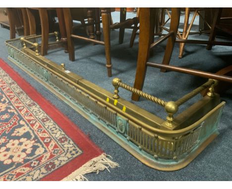 An antique brass pierced fire fender L 158 cm, together with another extending brass fender. (2)