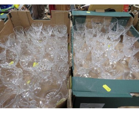 Four trays of assorted glassware to include a large quantity of cut glass drinking glasses