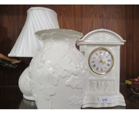 A Belleek mantel clock, vase and lamp (3)