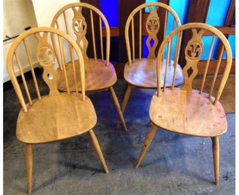 A SET OF FOUR LIGHT ERCOL WINDSOR CHAIRS  with fleur de lys splat backs