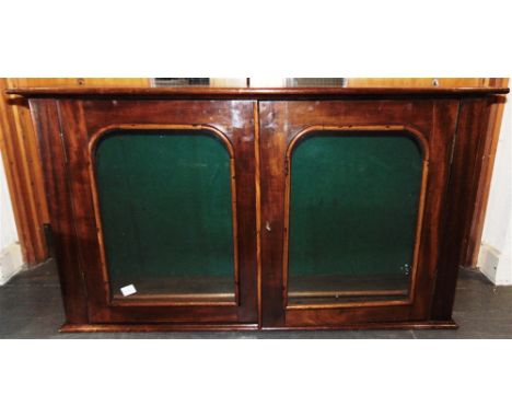 A MAHOGANY GLAZED WALL CABINET  with adjustable shelf to interior, 106cm wide 27cm deep 60cm high