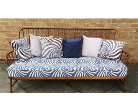 AN ERCOL THREE SEATER STICKBACK SOFA  185cm wide, with re-upholstered cushions 