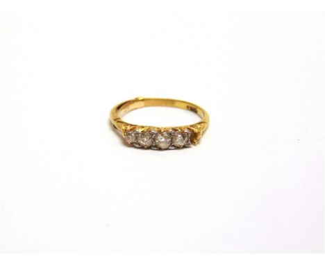 A DIAMOND RING  stamped '18ct', set with four graduated old brilliant cuts and one setting vacant, finger size R 1/2, 3g gros