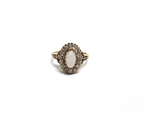AN OPAL AND DIAMOND CLUSTER RING unmarked, the oval cabochon enclosed by fourteen old brilliant cuts totalling approximately 